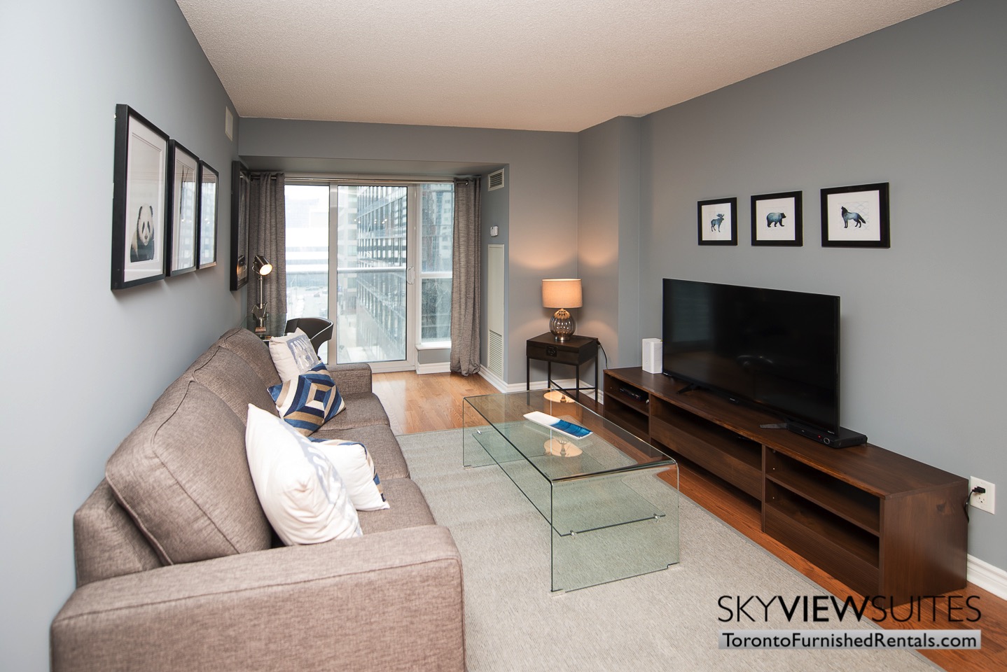 Wellington and Blue Jays Way executive rentals toronto living room pillows and tv set
