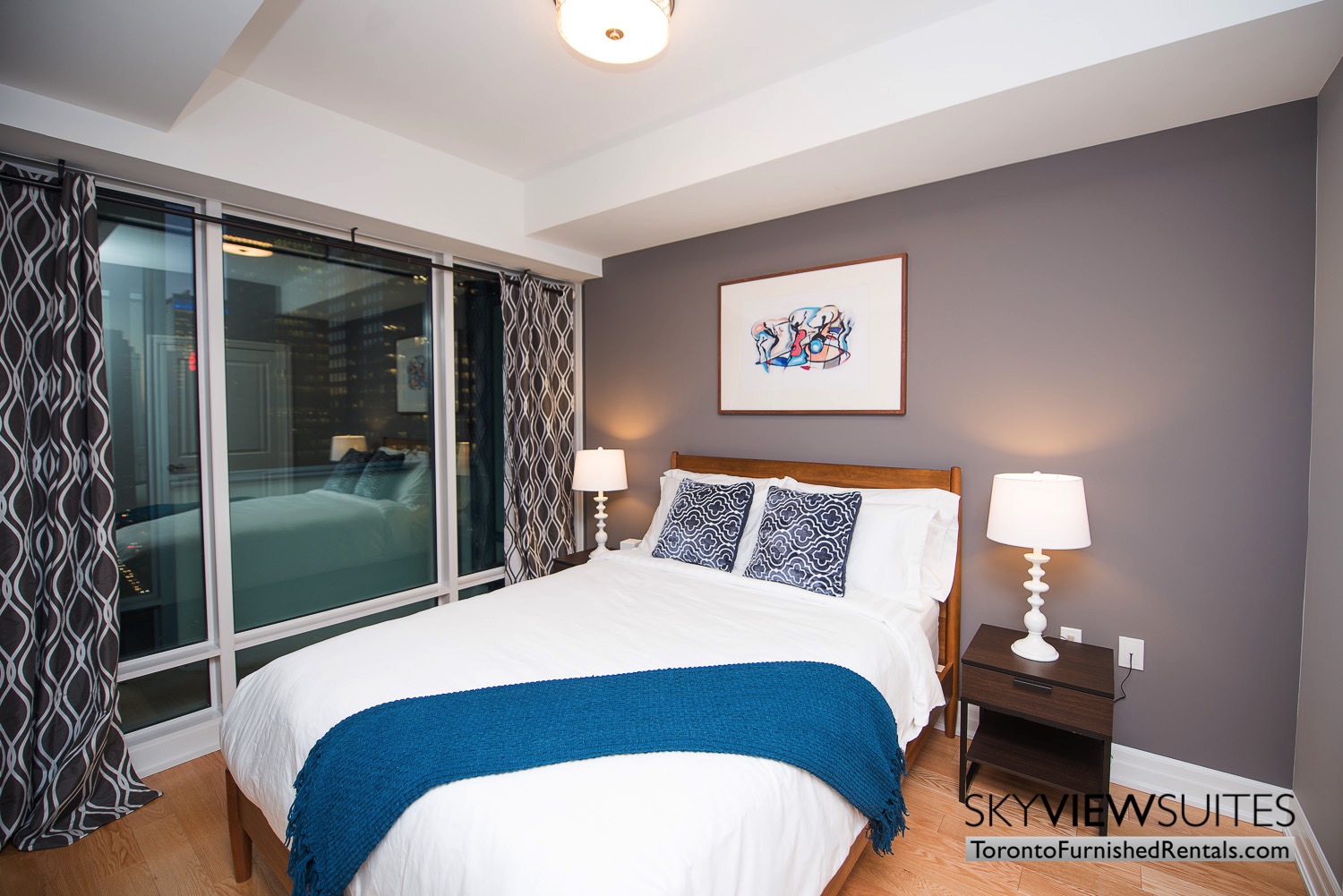 Yonge & Front serviced apartments toronto blue throw in bedroom