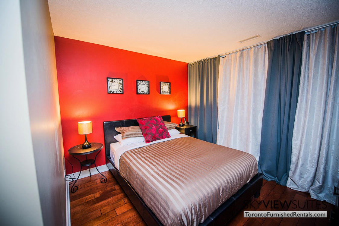 Yonge and Sheppard serviced apartments toronto bedroom with red wall