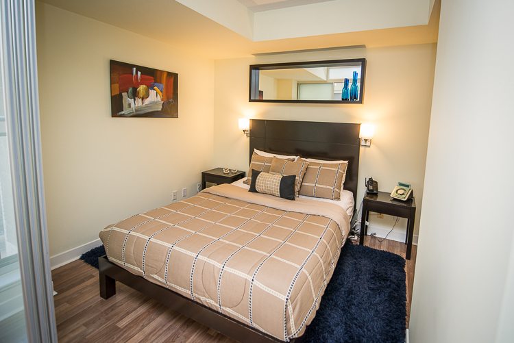 8 Colborne Street executive rentals toronto bedroom with blue rug