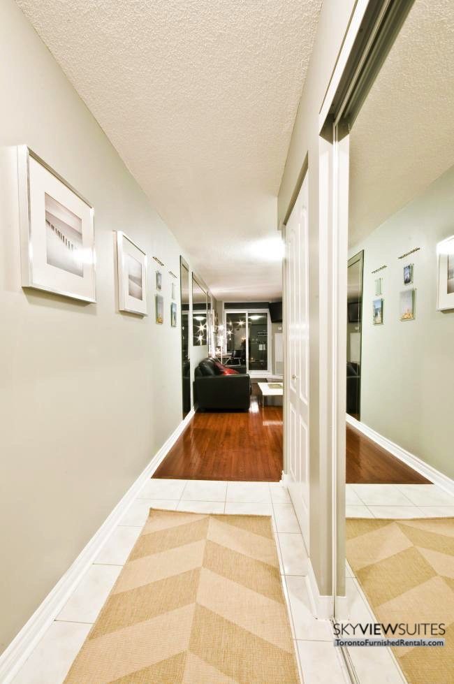 North York executive rentals Toronto front hallway with yellow rug
