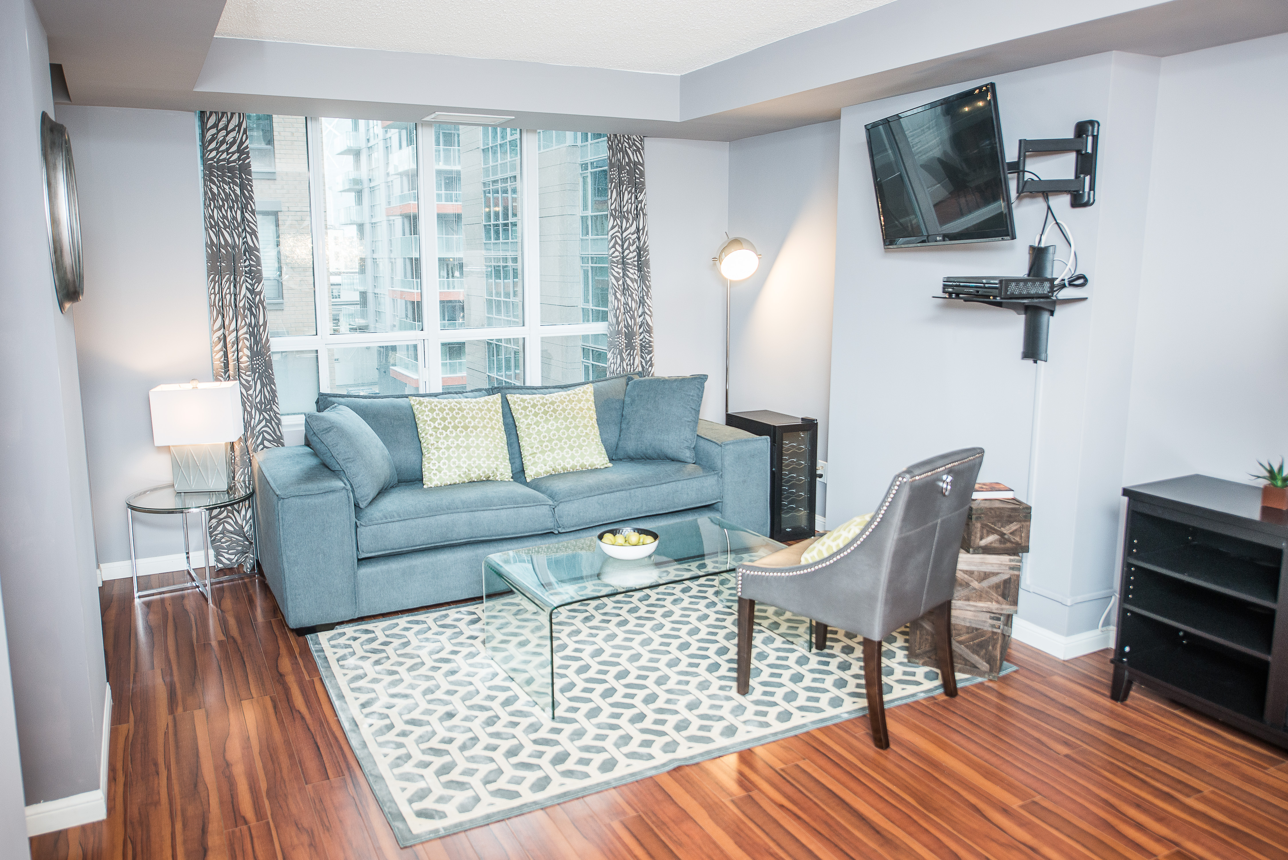 serviced apartments toronto financial district living room with wall-mounted television