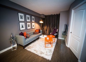 short term rentals toronto the empire living room with television and couch