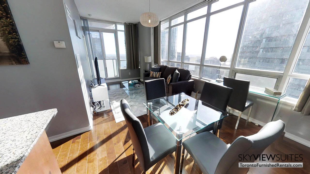 furnished rentals toronto Maple Leaf Square living room with dining area and skyline view