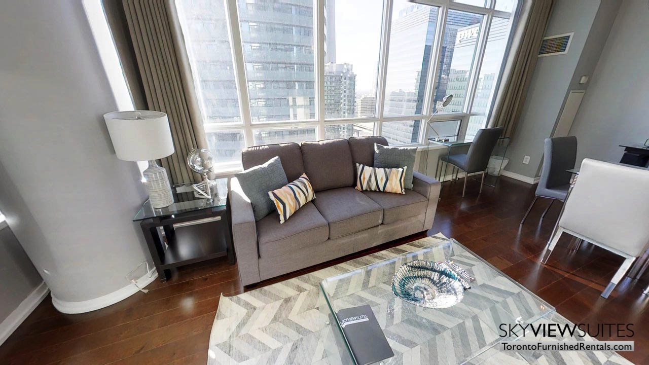 furnished rentals toronto Maple Leaf Square living room featuring couch, coffee table and view of the city