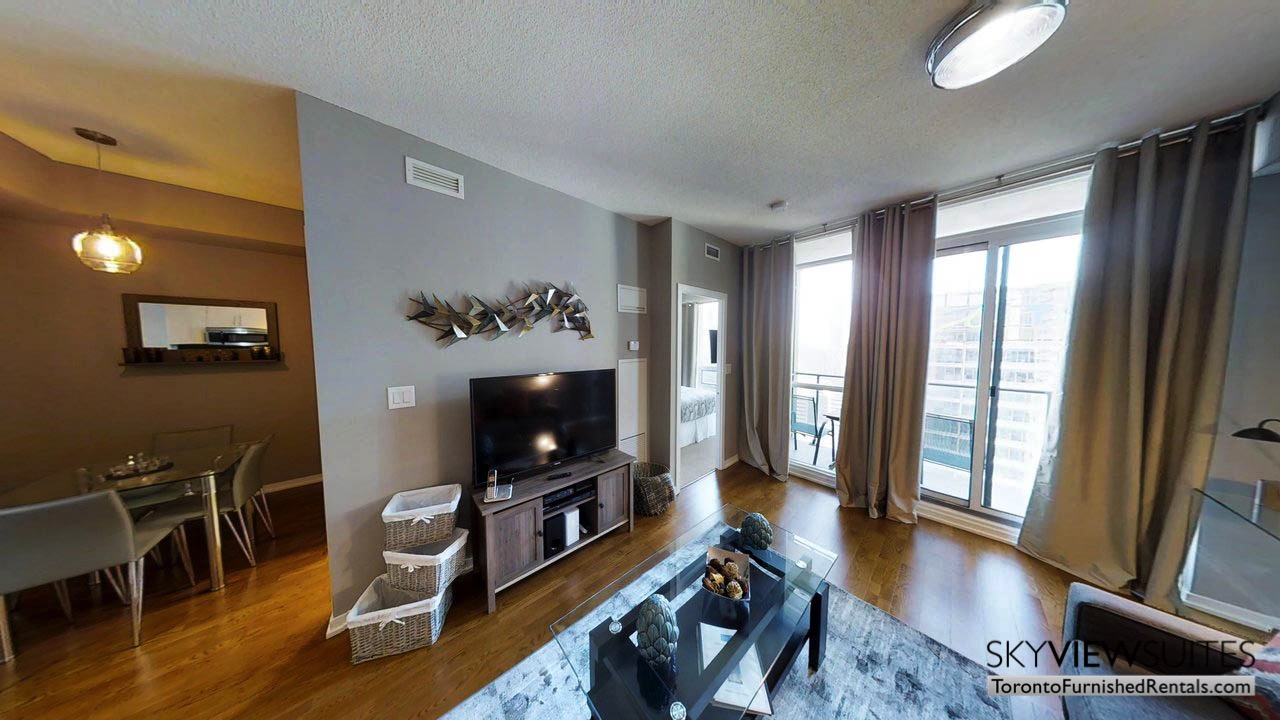 furnished apartments toronto Maple Leaf Square living room with coffee table tv and view of the city