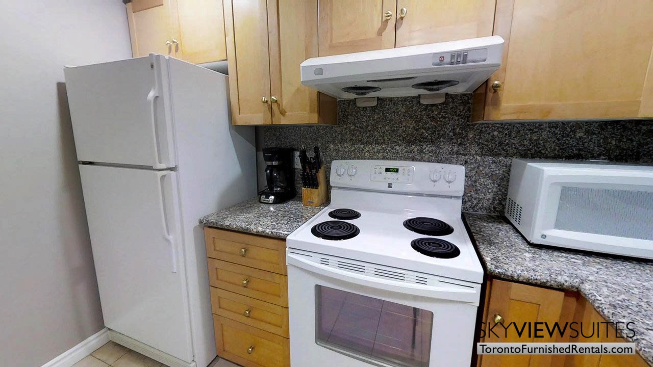 furnished rentals toronto simcoe and richmond kitchen with fridge and stove