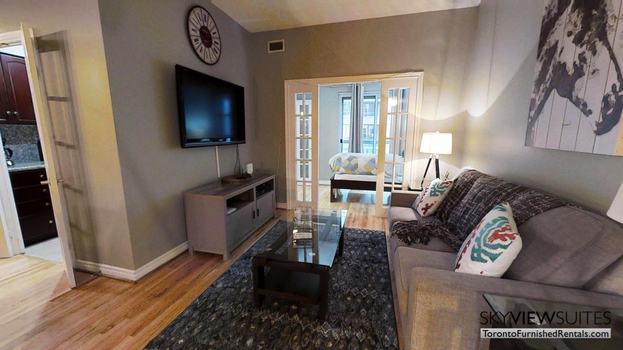 short term rentals toronto qwest couch in living room and television