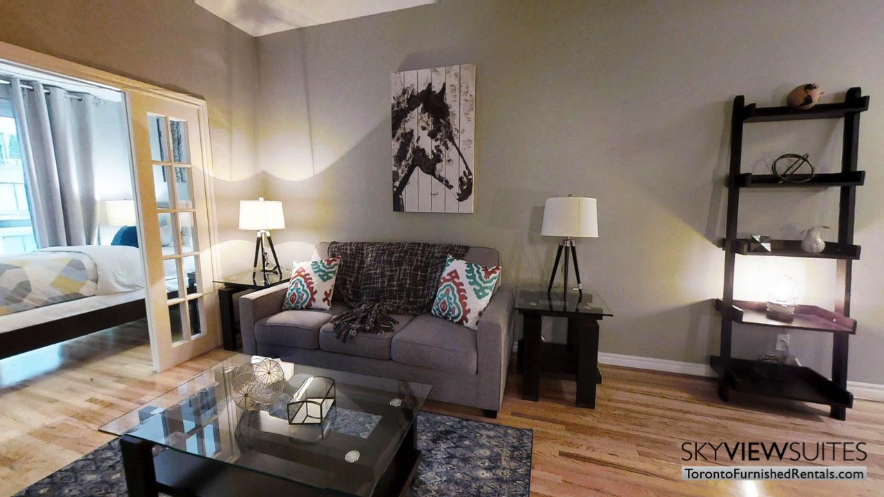 short term rentals toronto qwest living room with door to bedroom