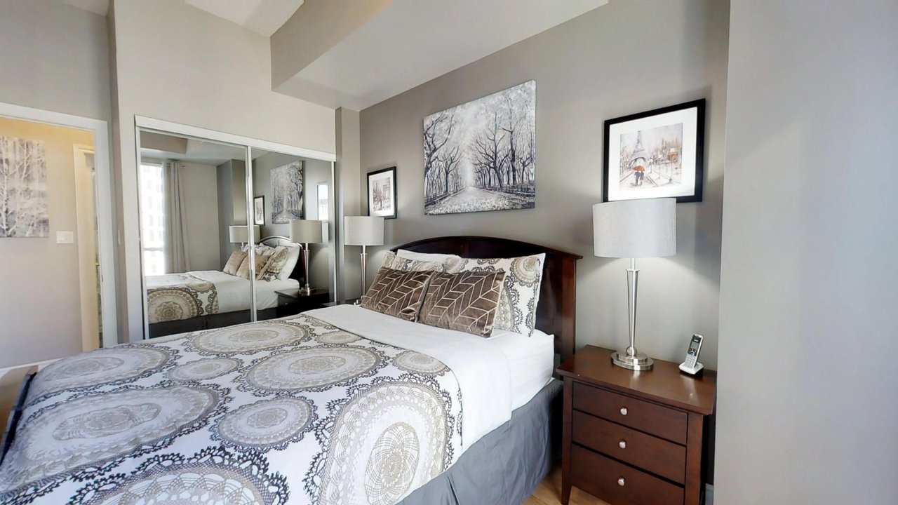 furnished apartments toronto QWEST bedroom with mirror and landline