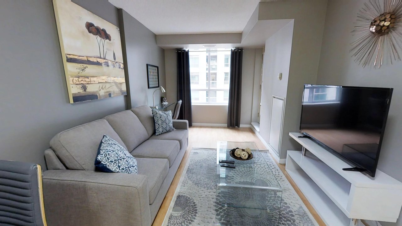 executive rentals toronto university plaza living room with couch tv and window