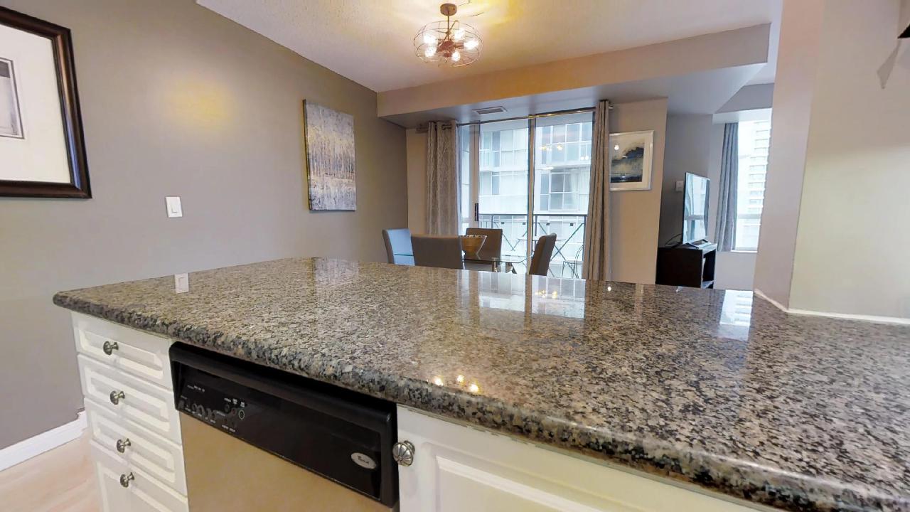 kitchen counter and dining area in a furnished apartment near the entertainment district