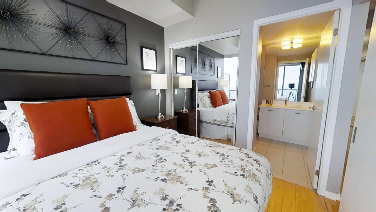 bedroom and bathroom in a fully furnished toronto condominium near bay and college