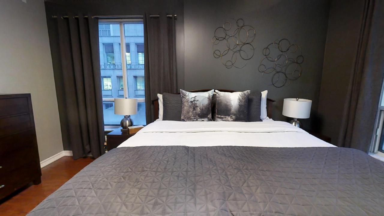 Queen sized bed in a furnished apartment in Toronto, in Qwest condominiums