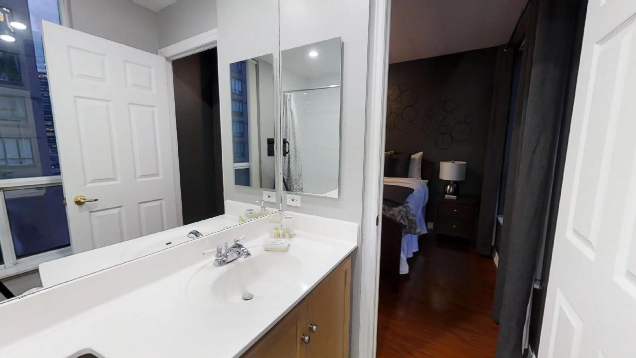 bathroom and bedroom in a furnished apartment near the Financial District, in Toronto