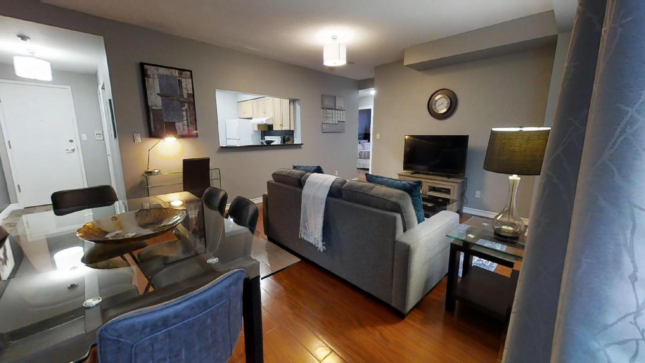 the living room and kitchen in a Qwest two-bedroom furnished apartment, in Toronto