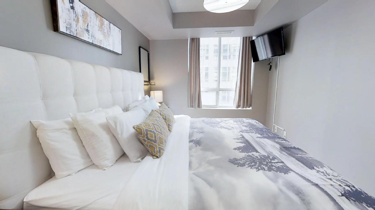 Master Bedroom in a Toronto furnished apartment at Richmond and Simcoe
