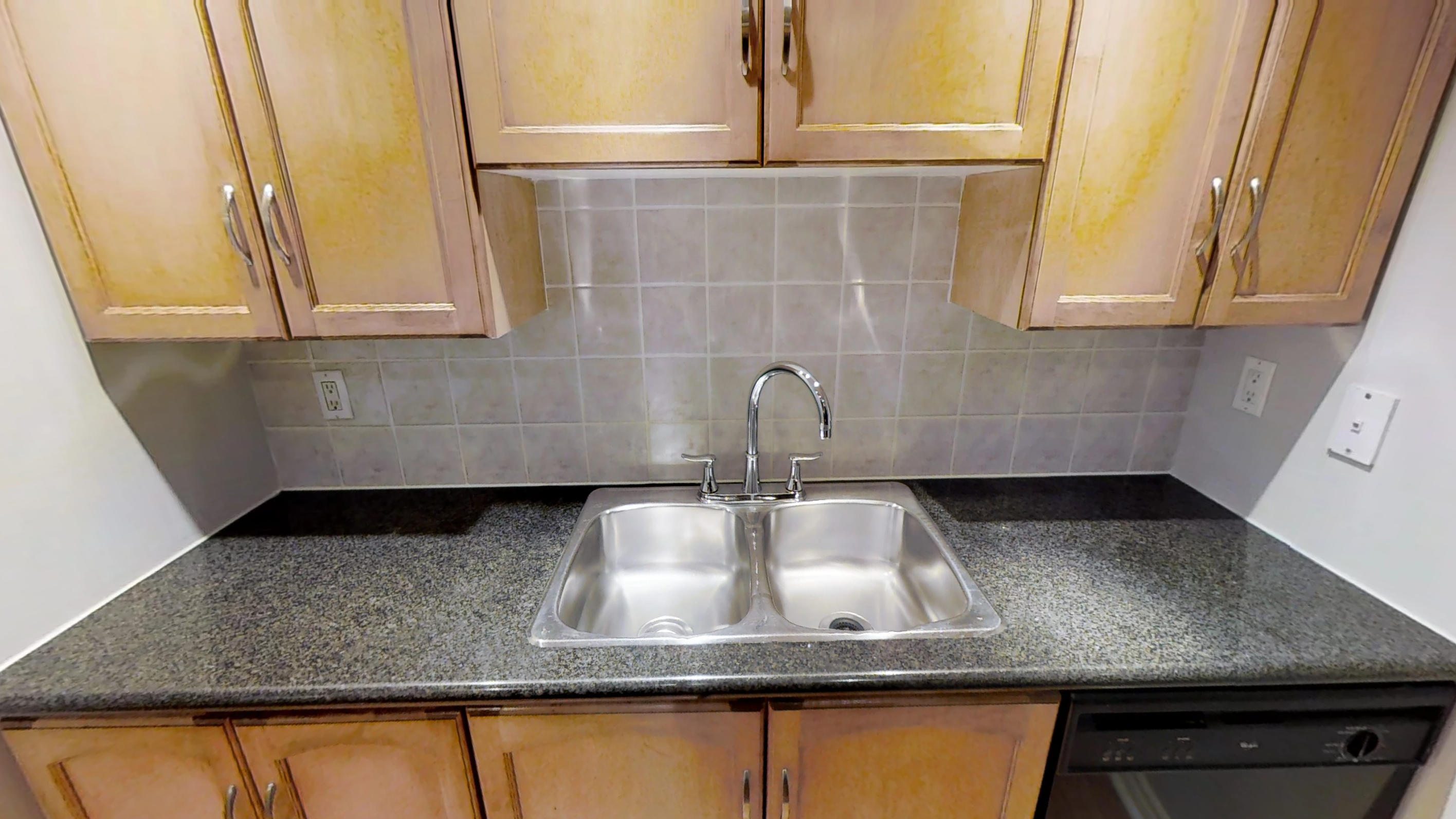 the kitchen sink of a furnished apartment near Toronto's entertainment district