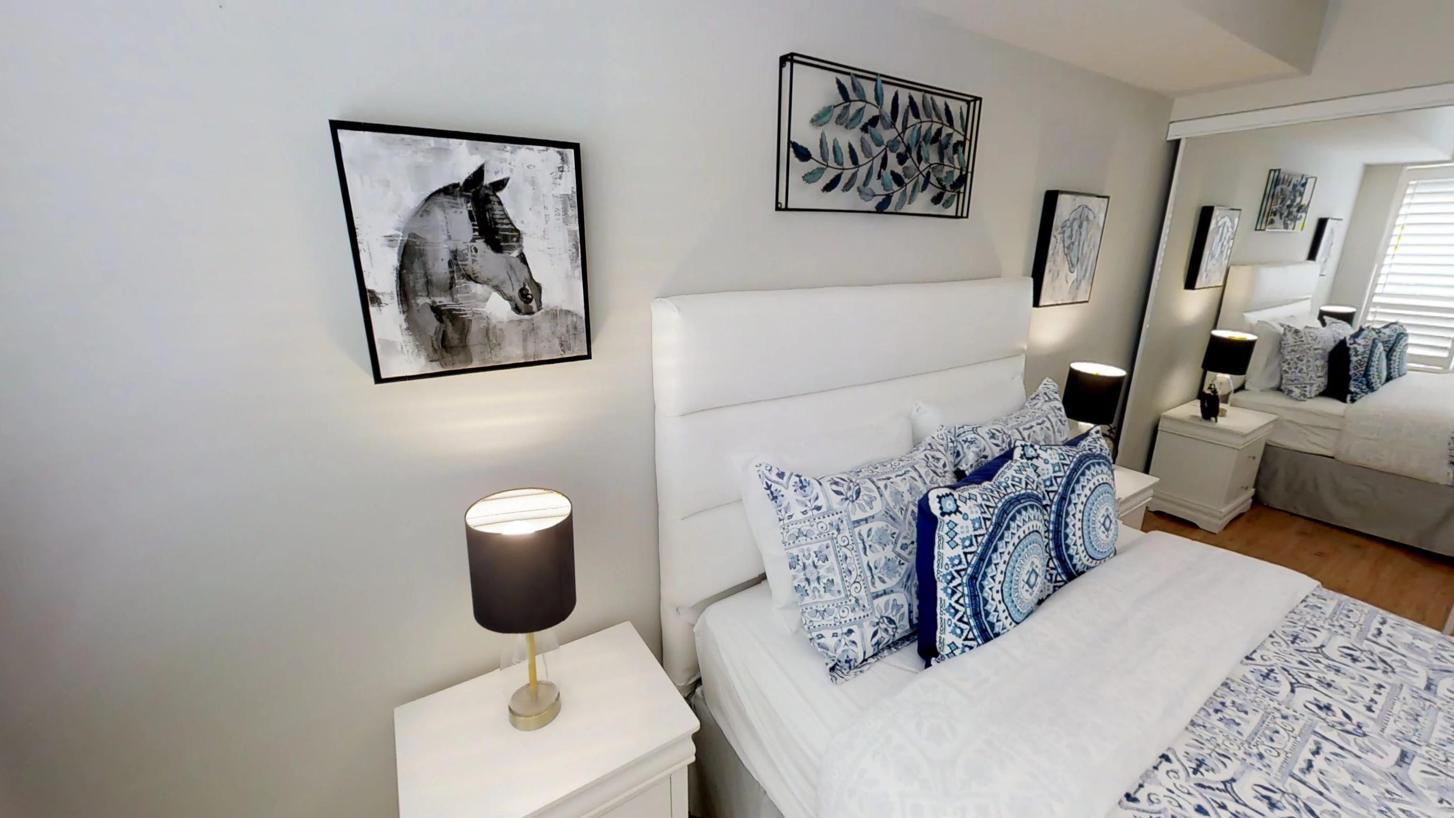 Horse art and bed in master bedroom in a fully furnished serviced apartment in downtown Toronto, near the Roger's Centre