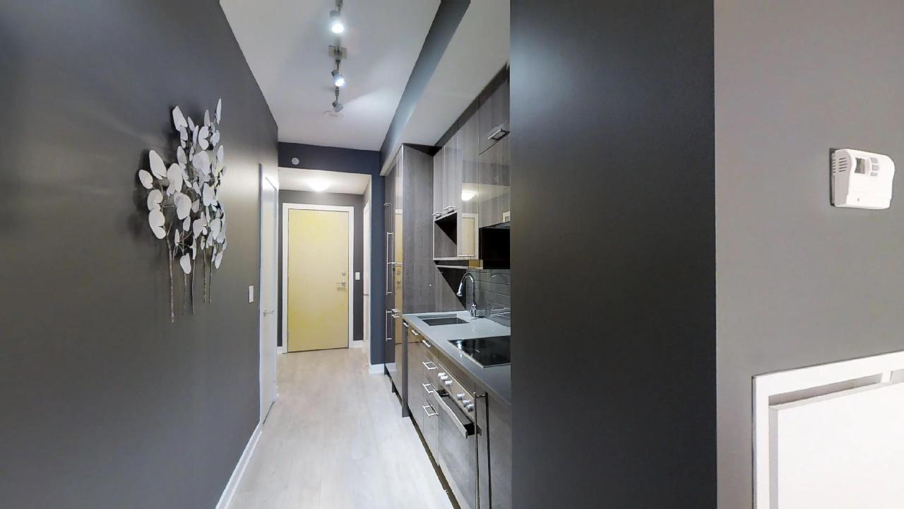 a yellow door and front hallway in a toronto furnished apartment