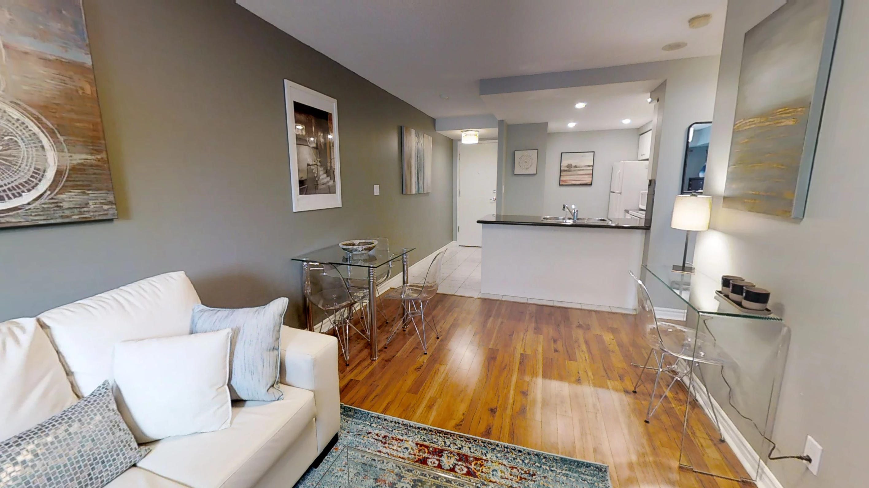 view of the kitchen and hardwood floors in a furnished apartment in downtown toronto at 168 simcoe street