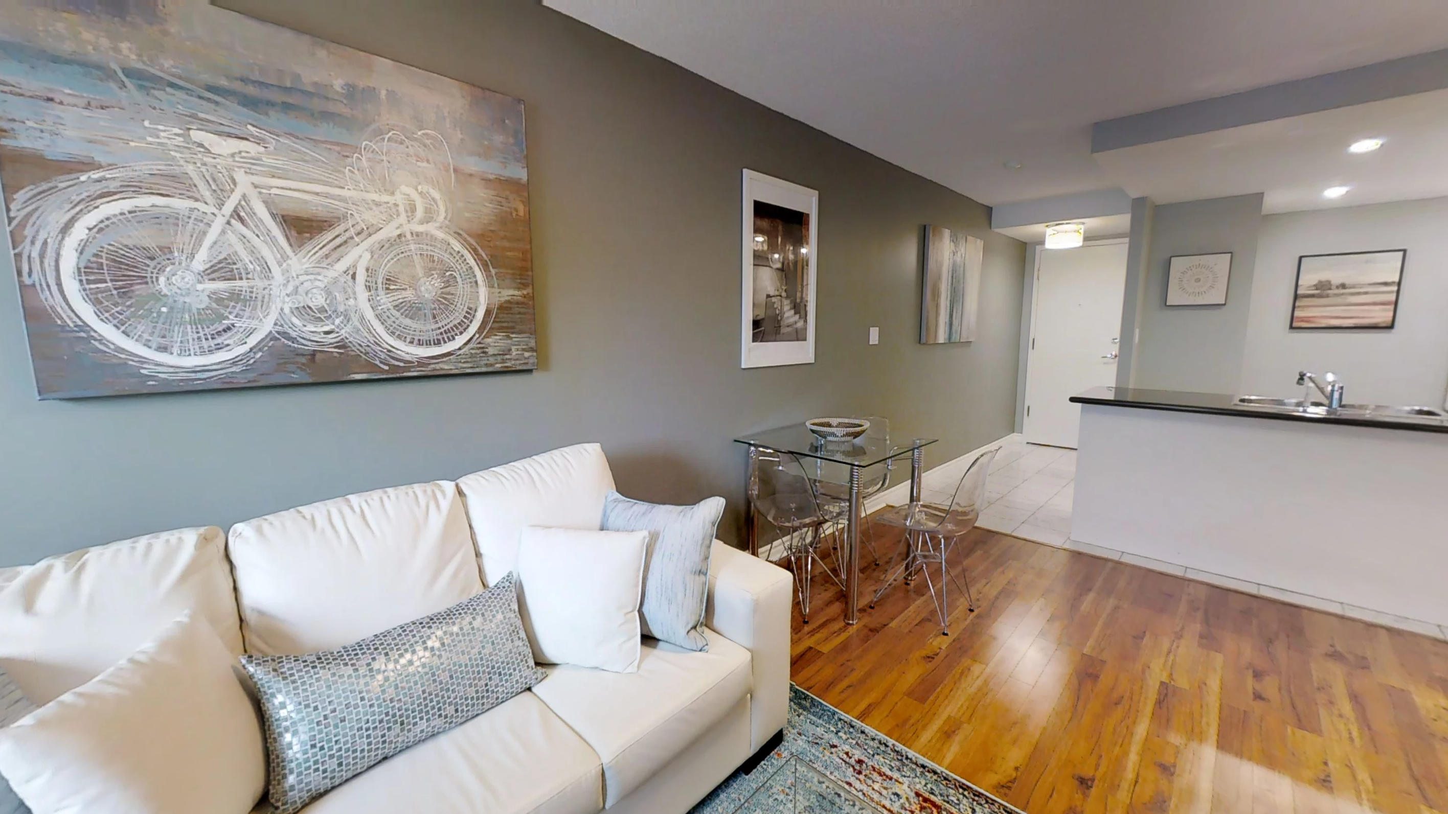 area rug over the hardwood floor in a toronto furnished apartment near simcoe and queen