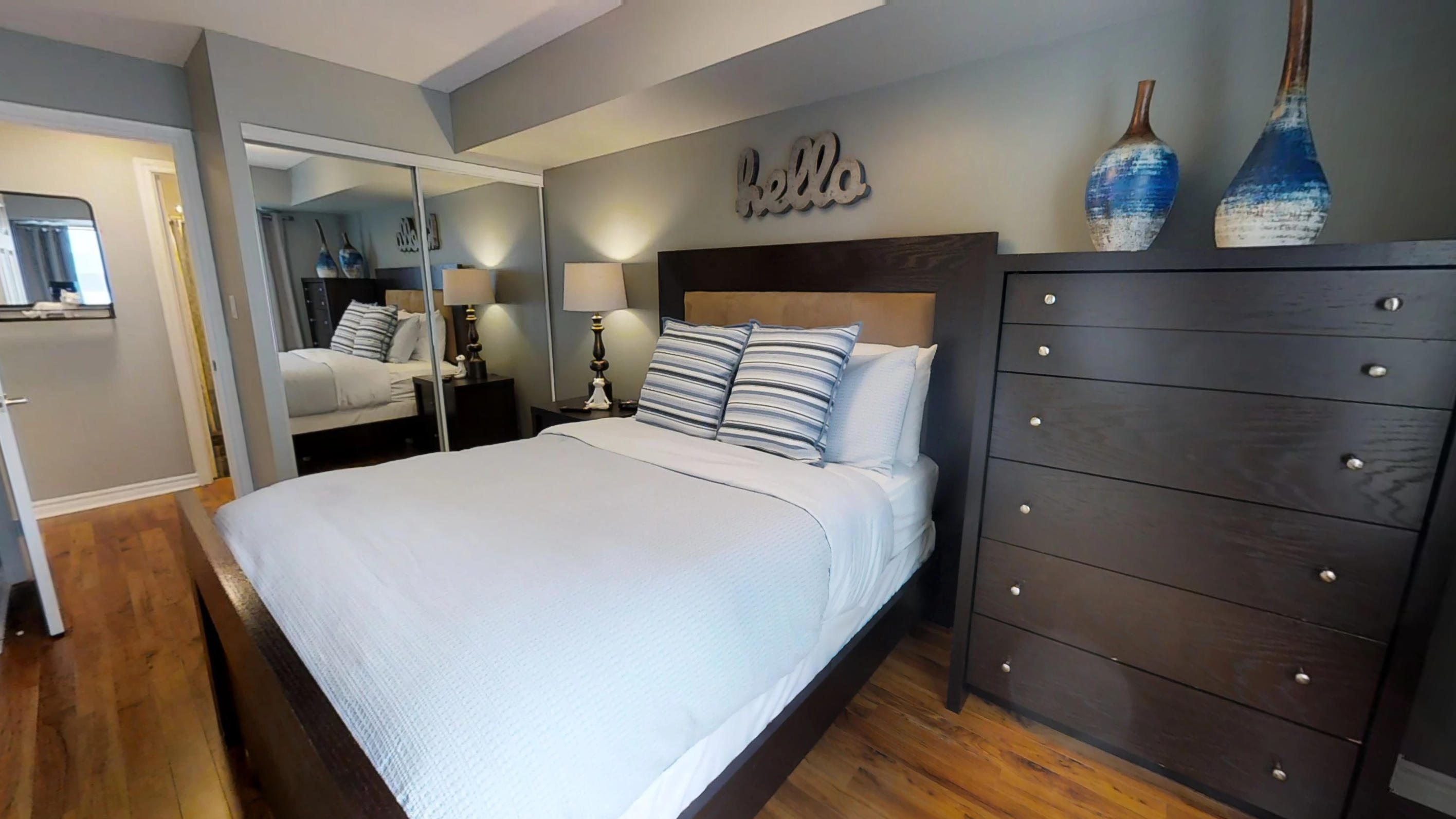 furnished bedroom in a corporate stay apartment located near Bay street in downtown Toronto